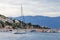 View of the sea, mountains  and ship in cloudy weather. Coast with houses on background