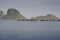 View of the sea and red sea bridge with a boat laying near a bridge, mountain in background,sunset moment,peace wave of sea