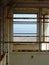 View of the sea through a rusty abandoned beach shelter