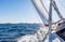 View of the sea, sky, sail and foam waves from the yacht moving forward to the horizon under the sails