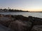 View of the sea and stones on the Pedregalejo Beach at dusk