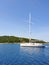 View from the sea to a luxury sailing white yacht and the islands