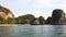 View from sea on tropical coast with cliffs covered by greenery of Koh Hong Island