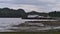 View of Seagate Pier in the harbour of Port Hardy, Vancouver Island on cloudy day in autumn season with rocky beach.