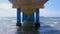 View on seascape with stormy wave and cloudy sky from under the pier.