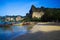 View on secluded beach with high steep limestone cliffs and traditional thai long-tail boats - Railey, Krabi, Thailand