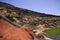 View on secluded deep green lake Lago verde in lagoon surrounded by impressive cliffs - El Golfo, Lanzarote