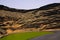 View on secluded deep green lake Lago verde in lagoon surrounded by impressive cliffs - El Golfo, Lanzarote