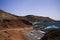 View on secluded lagoon surrounded by impressive rugged weathered cliffs in different colors - El Golfo, Lanzarote