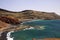 View on secluded lagoon surrounded by impressive rugged weathered cliffs in different colors - El Golfo, Lanzarote