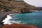 View on secluded lagoon surrounded by impressive rugged weathered cliffs in different colors - El Golfo, Lanzarote