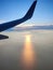 The view seen from inside the plane, looks like the sun is about to set