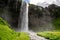 View of Seljalandsfoss Waterfall, tourist popular natural attraction in Iceland