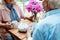 View of senior couple holding cups while sitting near teapot