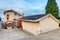 View of separate garage with concrete driveway.