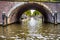 View of seven centuries old bridges in a straight line over the Reguliersgracht, viewed from a canal boat in Amsterdam