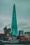 View of the Shard skyscraper, tallest building in London city. HMS Belfast ww2 destroyer anchored in the Thames river in