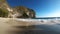 View of sheer limestone cliffs and giant waves on the island of Nusa Penida, Indonesia. bathing people far in the dangerous waves