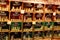 View on shelf made by wooden wine cases inside French shop with typical products. Glass jars with perfumed candles bougies prese