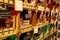 View on shelf made by wooden wine cases inside French shop with typical products. Glass jars with perfumed candles bougies prese