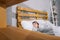 view through shelves on girl sleeping on white pillows