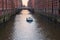 View at a ship in a canal of Elbe river in Hamburg`s Speicherstadt warehouse district, Germany