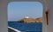 View from ship`s door of lighthouse and agios Nikolaos church. Kea,Tzia island, Greece. Sky background.