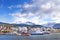 View of ships in the port of Ushuaia against a landscape showing the city and the Martial mountains, surrounded by a