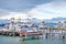 View of ships in the port of Ushuaia against a landscape showing the city and the Martial mountains, surrounded by a