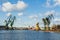 View of the shipyard with historical cranes in the industrial part of the city Gdansk in Poland Polska. The shipyard is