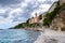 View of the shore buildings against the background of the cloudy sky. Rab, Croatia.