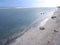 View of the shoreline from above, white waves, beach sand, clear water and rocks. Panoramic view