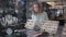 View through showcase glass of young woman choosing adornments made from natural gemstones in jewelry store