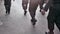 the view shows the half body of a group of men walking wearing boots like police masculinity symbol