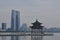 View on Shuzhou business centre with pagoda and lake in foreground