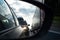 View in the side mirror of a car on the road. Traffic congestion, a large congestion of cars, difficult traffic