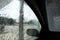 View of side window of car covered in soap and water seen from the interior during an automated wash