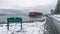 View of sign Barge Chilling Beach with   large barge in the background. Snow storm and extreme cold weather in Vancouver