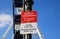 View on sign with information prohibited to rest and sit verweilverbotszone, blurred ferris wheel background