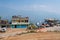 View of Sikkim village with affordable home stays for tourists, blue sky and Himalayan mountains in the background. Sikkim has a