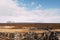 View from the Silfra Fault, in the Tingvedlir Valley in Iceland, the vast expanses of fields with yellow grass, car