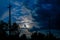 View of the silhouette of a village power line pole at night