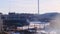 View of site of industrial plant on background of blue sky. Stock footage. Huge truck stands on parking lot at