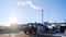 View of site of industrial plant on background of blue sky. Stock footage. Tractor leaves industrial protected area