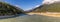 View of Skagway River and Skagway airport at sunset in Alaska. Golden hour. Blue cloudy sky and mountain peaks in the background