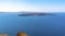 A view from Skaros Rock, Santorini towards the volcanic island of Nea Kameni