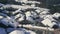 View from the ski lift to the snow covered roof of the chalet in the mountains