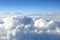 View on the sky and clouds from the porthole of a plane