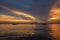 The view of the sky after the sunset is beautiful with the reflection of the fishing boat in the sea