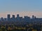 View of the skyline of Calgary, Canada in autumn with modern skyscrapers and trees in front viewed from Nose Hill Park.